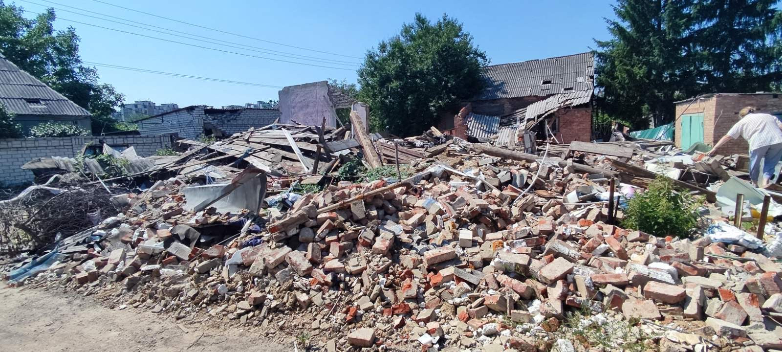 Pile of bricks and debris with a building in the background