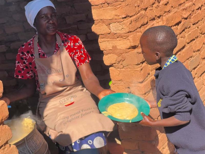 Woman and child in a rustic setting with food