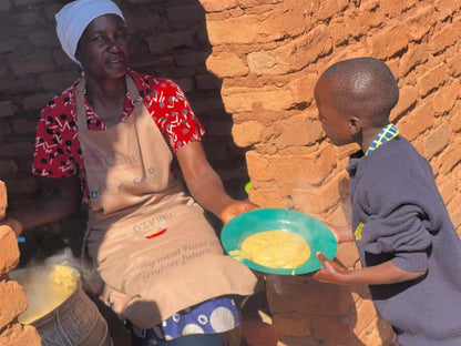 Woman and child in a rustic setting with food