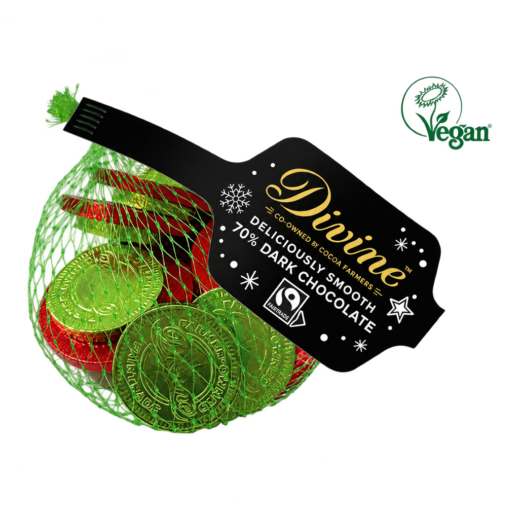 A net bag of Divine dark chocolate coins in green and red foil, with a black product label and green Vegan logo, on a transparent background.