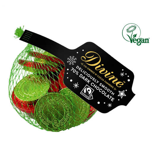 A net bag of Divine dark chocolate coins in green and red foil, with a black product label and green Vegan logo, on a transparent background.